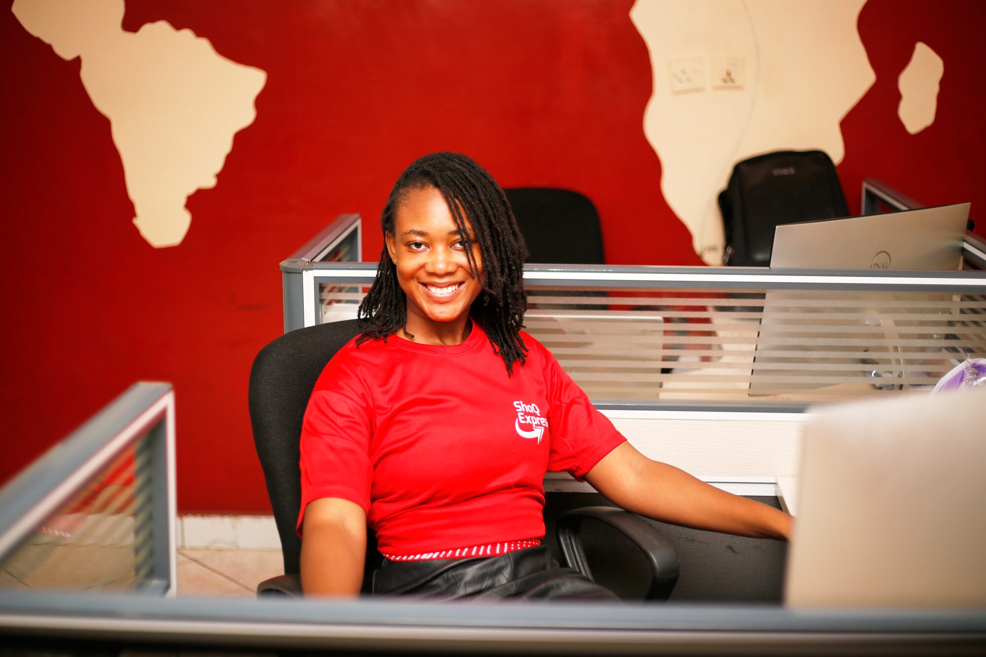 ShaQ Express team member at the office workstation, ready to help