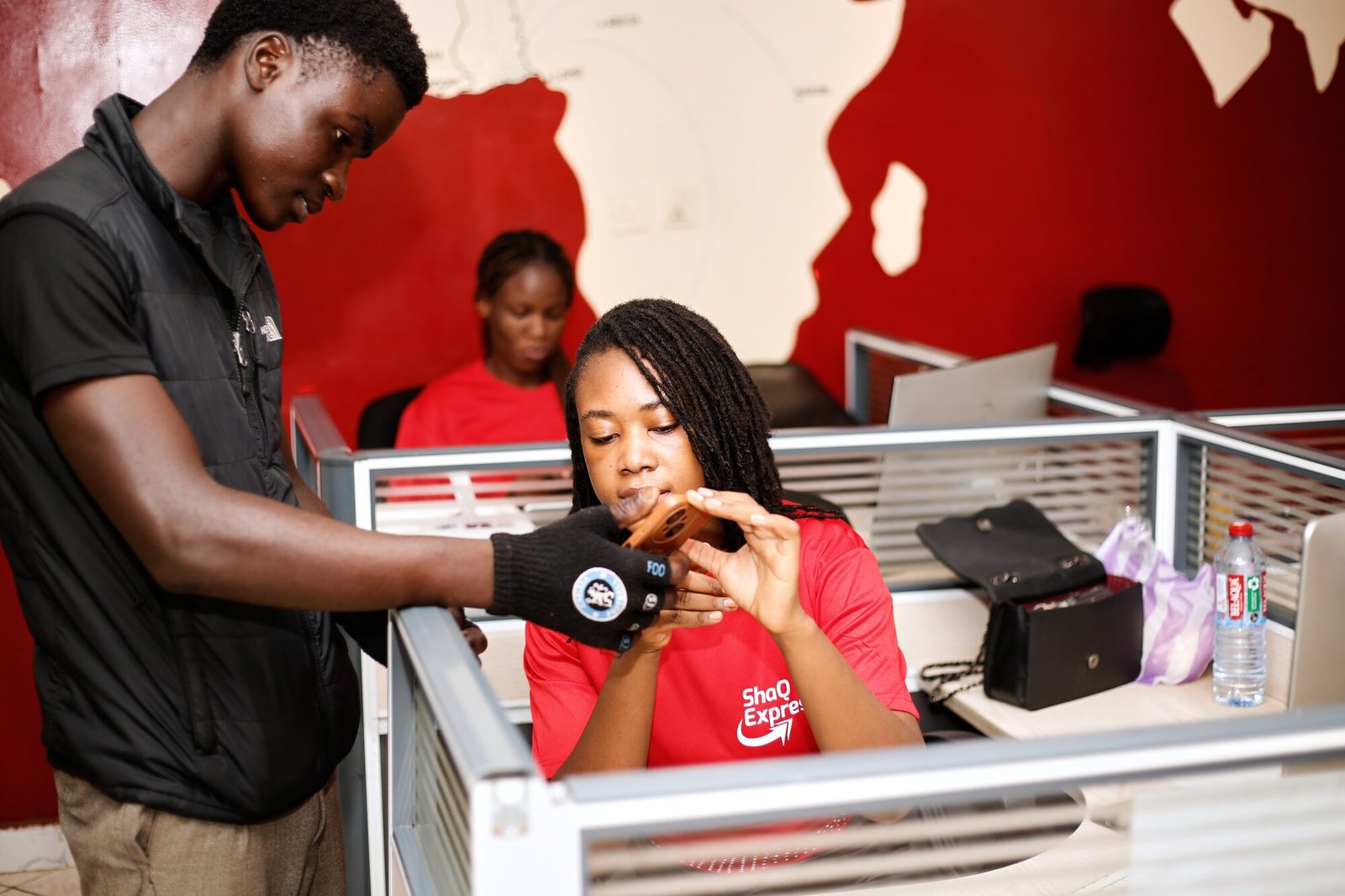 ShaQ Express team members reviewing a parcel at the Accra office